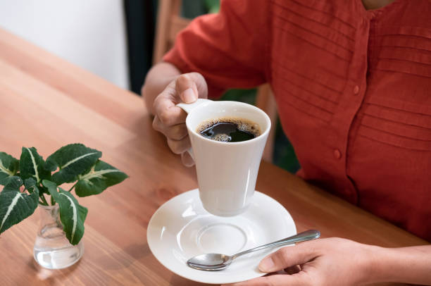 istock Woman drinking a coffee americano at the cafe. 1167817329