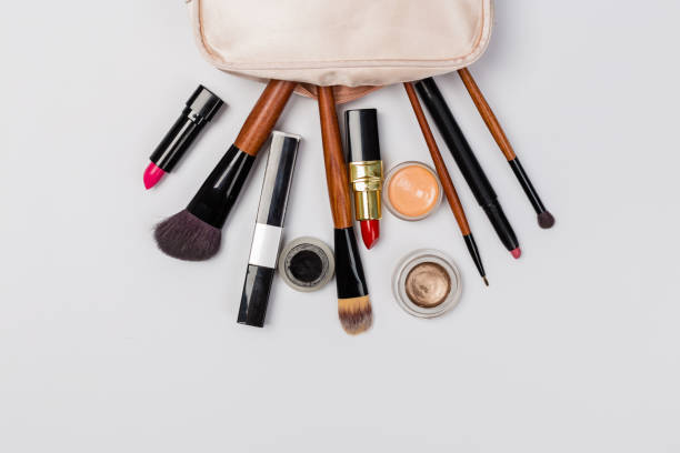 istock Makeup products with cosmetic bag and macaroons on light background 1167817369