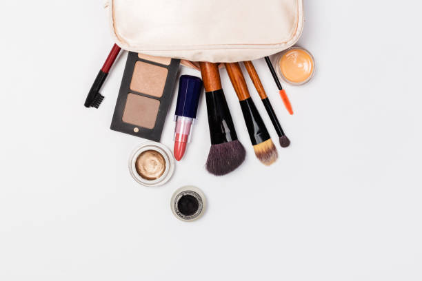 istock Makeup products with cosmetic bag and macaroons on light background 1167817537