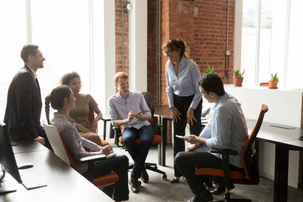 istock Cheerful diverse office workers and coach team leader at corporate training 1167824873