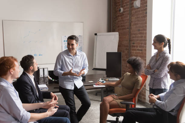 istock Confident business coach and diverse company employees at training 1167824905
