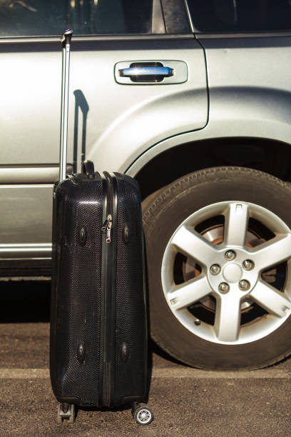 istock cropped view of suitcase at car 1167827675