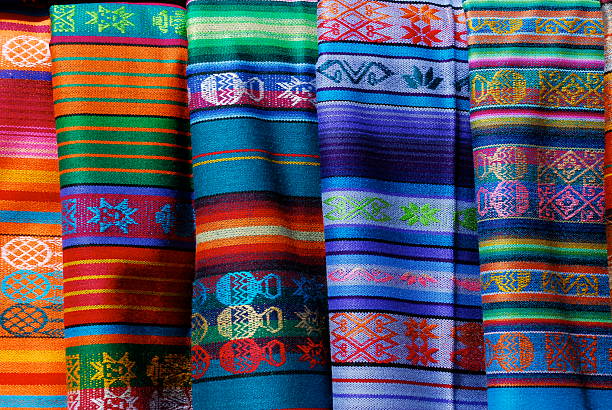 Mexican Blanket Background Colorful Mexican-made blankets for sale at an open-air market in Santa Fe, New Mexico. santa fe new mexico stock pictures, royalty-free photos & images