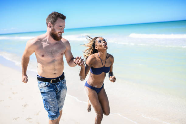 istock Mixed Couple Running At The Beach 1167833793