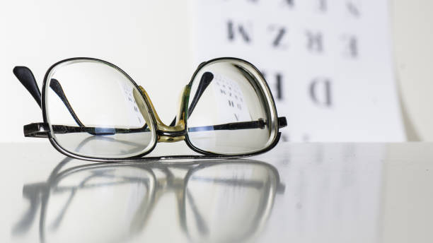 istock Old glasses on a table in a white room. 1167834696
