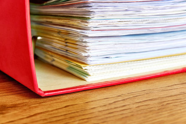 istock Red ring binder with business papers or bills 1167834815