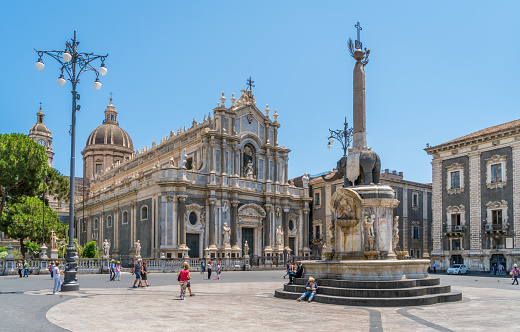 Piazza del Duomo in Catania on a summer morning, with Duomo of Saint Agatha and the Elephant Fountain. Sicily, southern Italy. July-02-2018