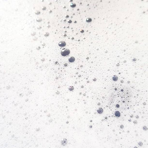 istock White foam with bubbles popping close up 1167837071