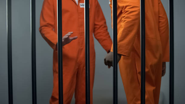 istock Aggressive black prisoner threatening caucasian inmate jail overcrowding assault 1167840010