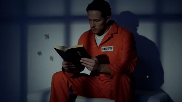 istock Imprisoned religious male reading bible, convicting in sins, feeling guilty 1167840016