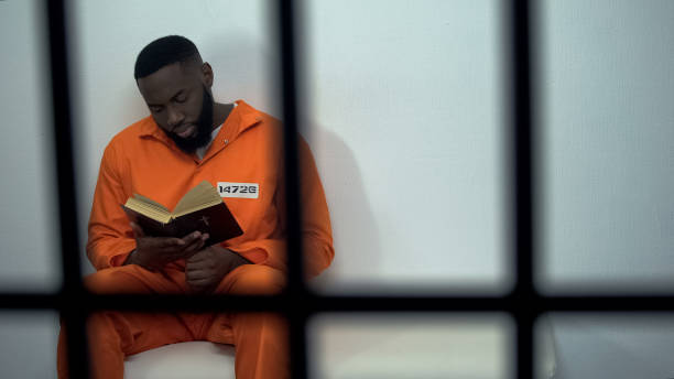 African-american prisoner reading holy bible, convicted sinner, religion African-american prisoner reading holy bible, convicted sinner, religion prisoner stock pictures, royalty-free photos & images