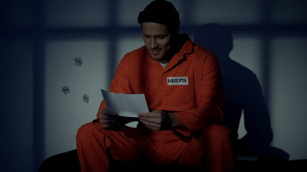 istock Prisoner receiving letter from family, feeling homesick, application for pardon 1167840089