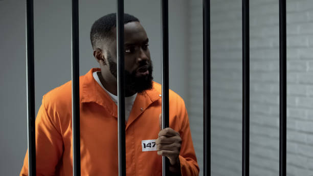 istock Aggressive prisoner holding bars and waiting for guard, inadequate criminal 1167840093