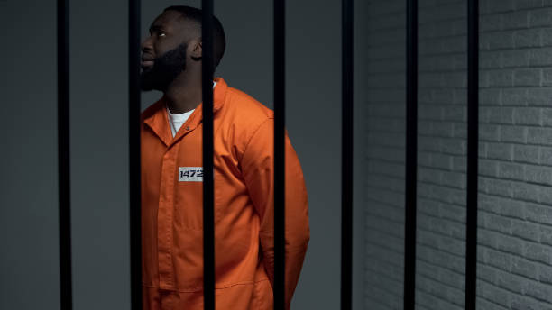 istock Nervous black prisoner waiting sentence in solitary cell, convicted criminal 1167840179