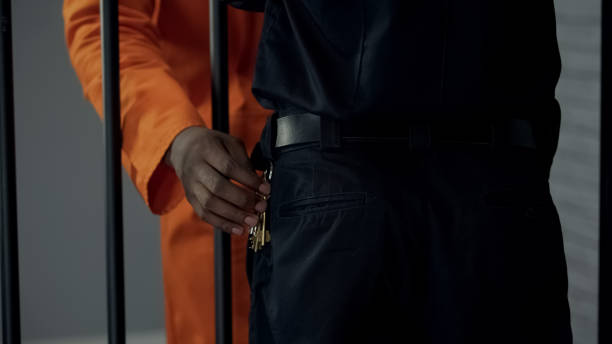 istock Afro-american prisoner stealing keys from security guard, preparing escape 1167840336