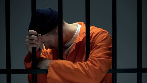 istock Desperate imprisoned male leaning on bars, feeling depressed, psychological help 1167840389