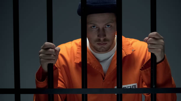 istock Disappointed male prisoner holding cell bars, losing hope for amnesty, justice 1167840414