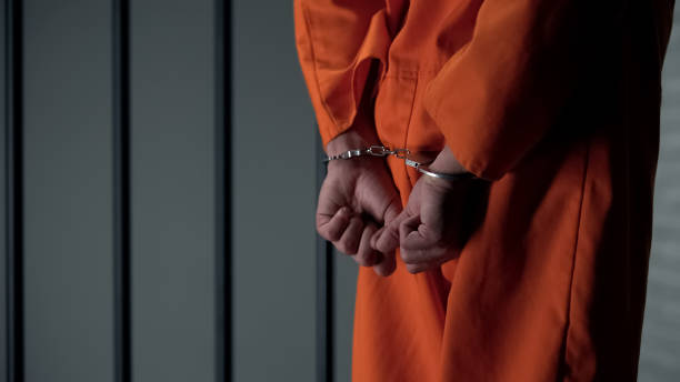 istock Prisoner with handcuffed arms behind back, another jail transfer, criminal 1167840469