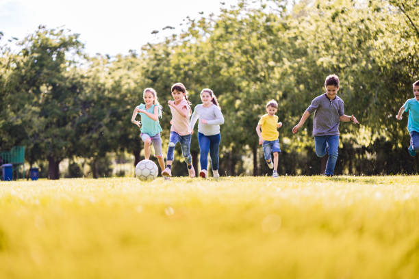 istock The kids playing soccer in the Park 1167841802