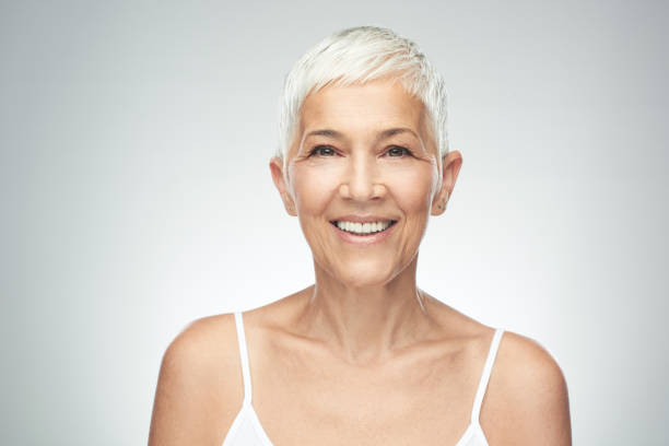 istock Senior woman posing in front of gray background. 1167841933