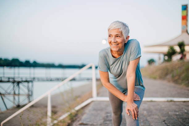 Senior woman exercising by the river