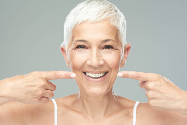 istock Woman pointing at her teeth. 1167841983