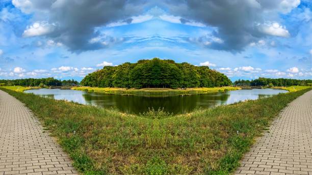 istock river embankment with a path.  horizon.  trees.  sky. 1167843222