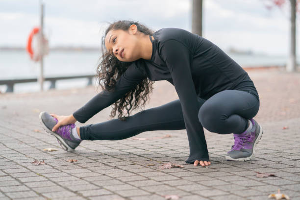 istock Woman stretching in the park 1167843328