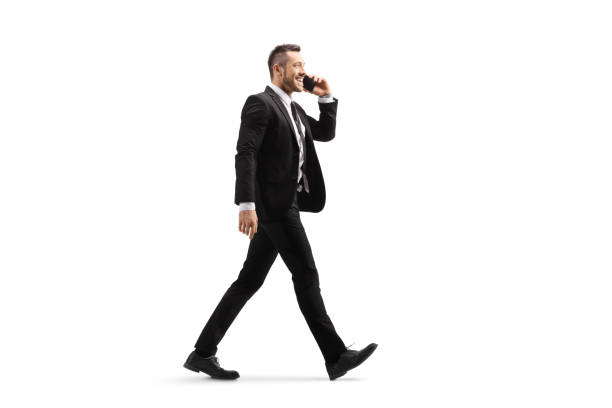 istock Businessman walking and talking on a mobile phone 1167844861