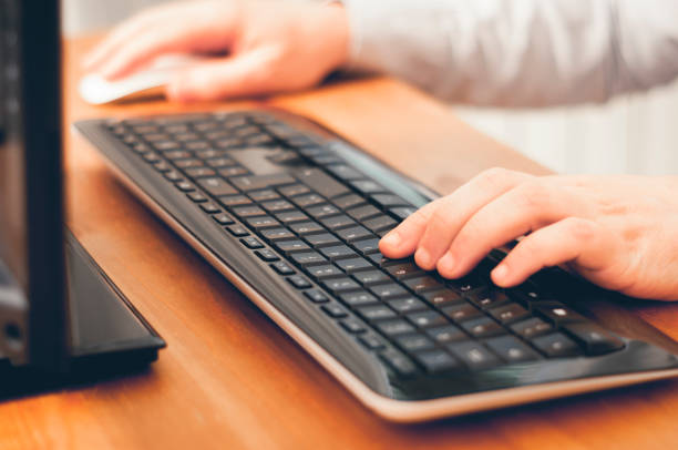 istock Man using computer, buy things online, searching informations or work at home. Soft focus image color graded 1167845597