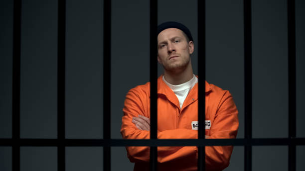 istock Imprisoned dangerous male criminal crossing hands on chest, looking directly 1167846632