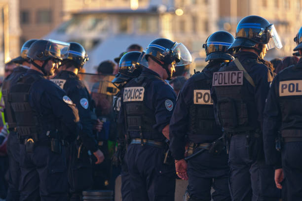 Braunschweig, Germany, January 8, 2022: Police officers in black uniforms block a gathering of right-wing demonstrators against restrictions because of the Corona pandemic