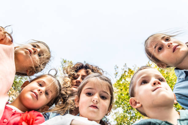 istock Below view of happy embraced kids in nature 1167846852