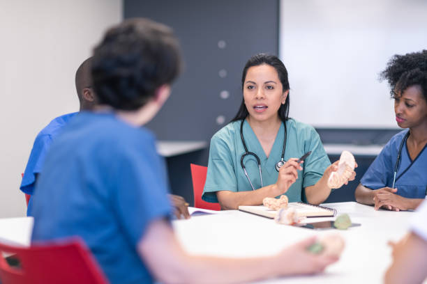 istock Hispanic female doctor leads medical training course in lecture hall 1167849766