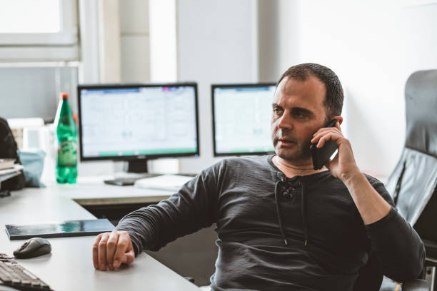 istock Male Engineer is with the Phone in his Office 1167850867
