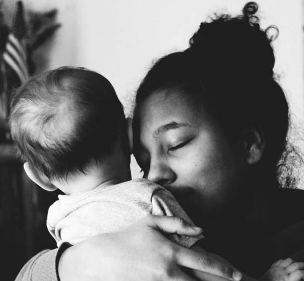 istock Teenager hugging baby 1167854103