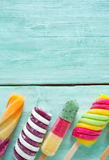 istock colorful popsicles on wooden surface 1167858778