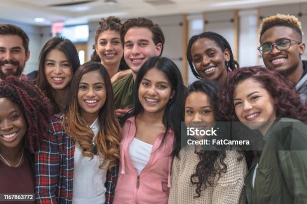 Multiethnic Group Of University Students Sitting Inside Together Stock Photo - Download Image Now