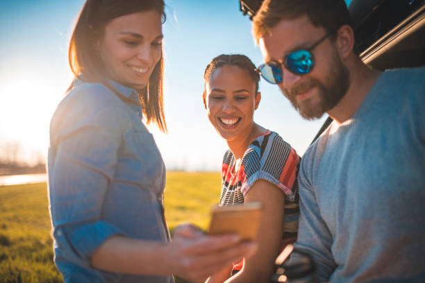 istock Friends standing next to a car and talking 1167863801