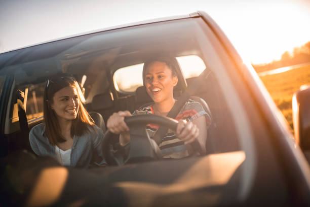 istock friends driving in a car on a sunny day 1167863805
