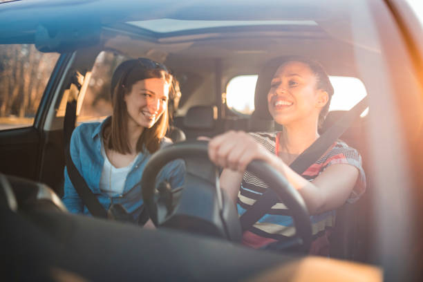 istock friends driving in a car on a sunny day 1167863809
