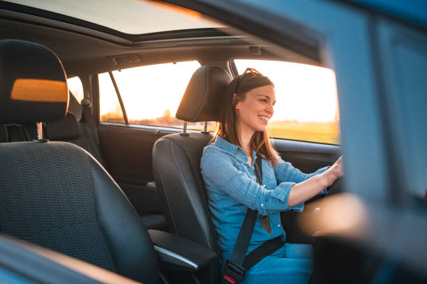 istock Young woman driving car on a sunny day 1167863815