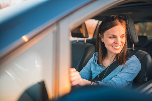 istock Young woman driving car on a sunny day 1167863818