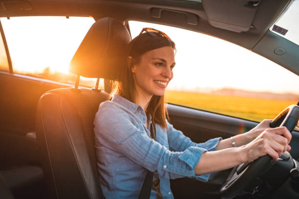istock Young woman driving car on a sunny day 1167863832