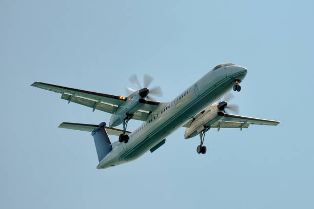 Small propeller airplane approaching the Quebec city airport during autumn day.