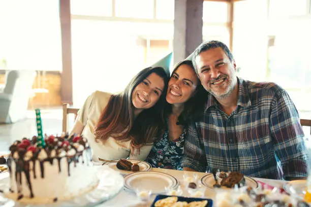 Father, mother and daugther celebrating a birthday party together