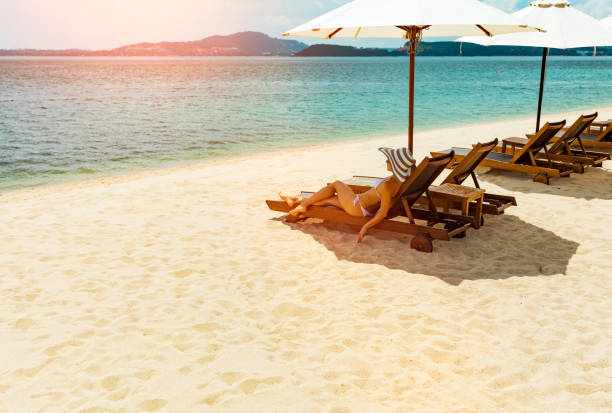 istock Woman in beach chair 1167870786