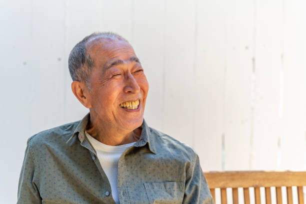 istock Happy Senior Asian Man Sitting in his Backyard 1167873934