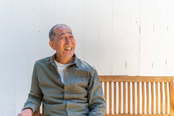 istock Happy Senior Asian Man Sitting in his Backyard 1167873938