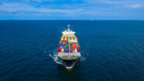 istock Container cargo ship carrying container for business freight import and export, Aerial view container ship arriving in commercial port. 1167876933